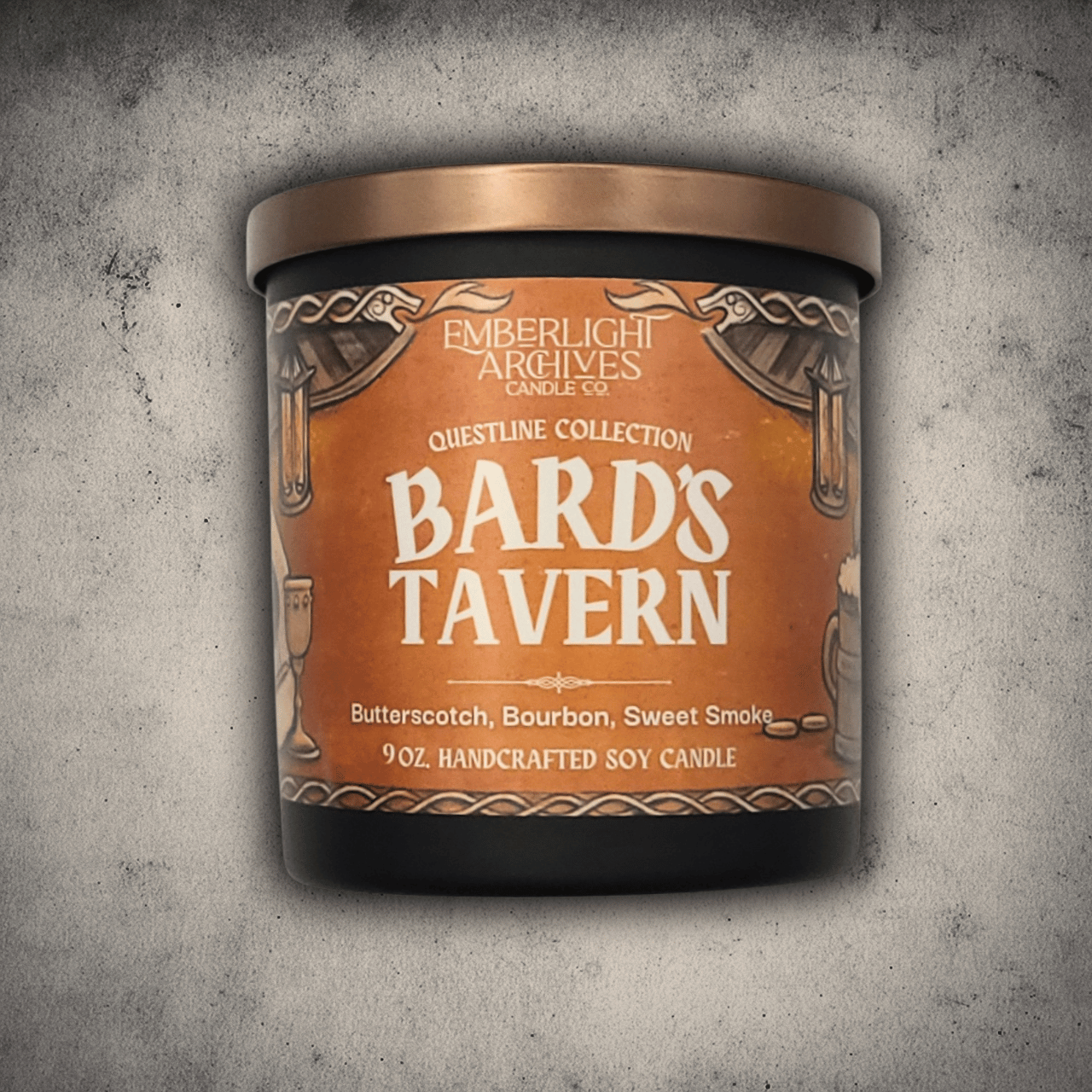 Emberlight Archives Bard's Tavern candle in a 9oz black glass jar with illustrated rustic tavern label against a gray stone background, Butterscotch and Bourbon scent.